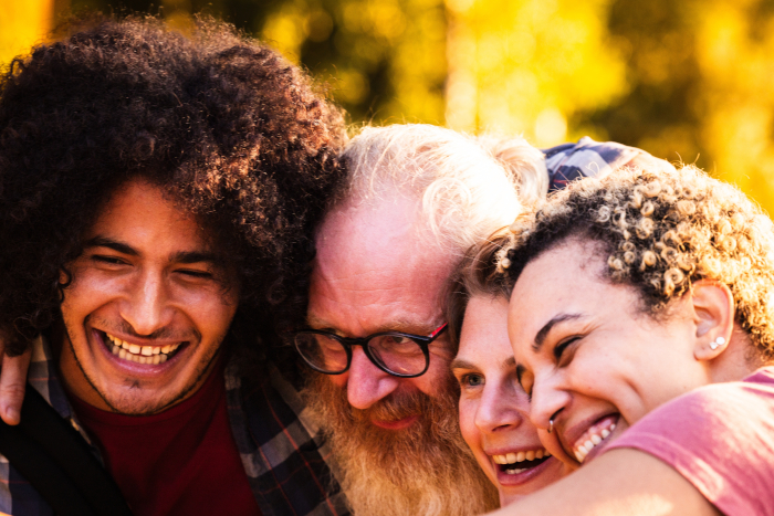 four people smiling